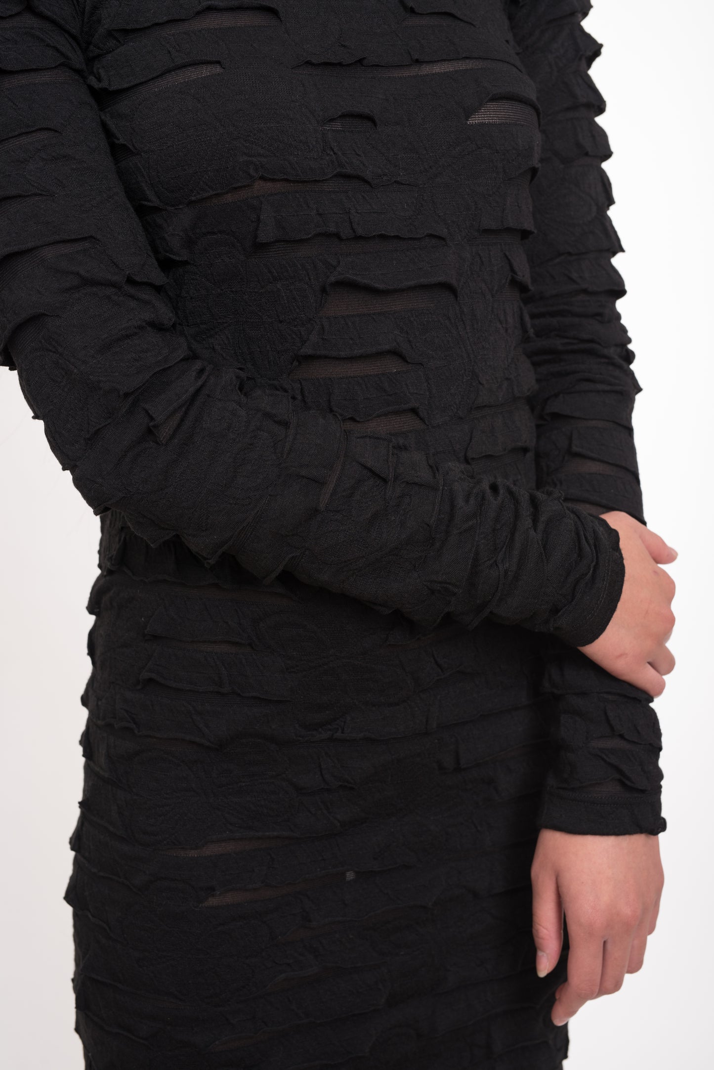 Zoomed-in sleeve and midsection showcasing the layered texture and sheer detailing