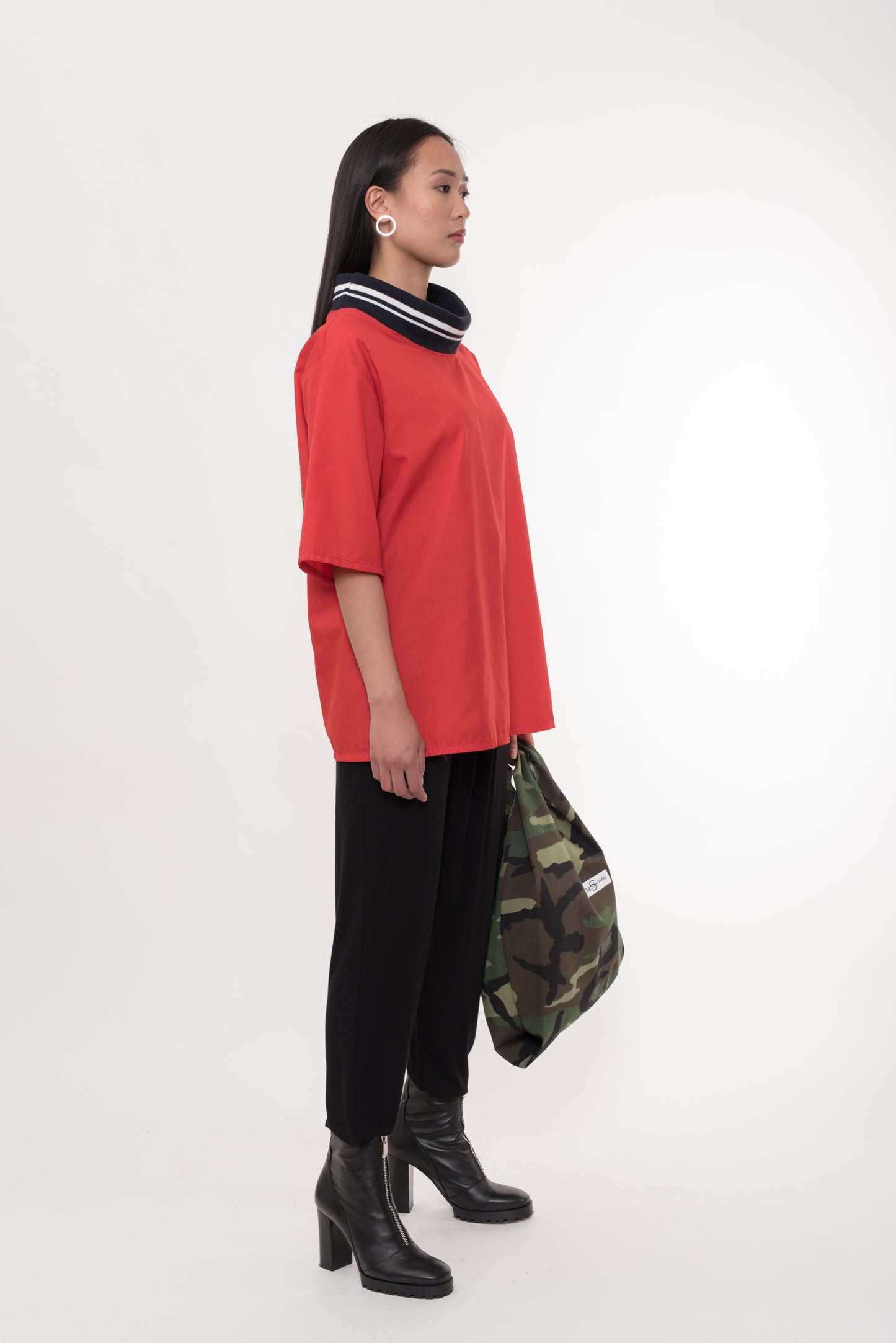 Model styled with Red Cotton T-Shirt, black trousers, and camo bag, full-length side view – Casa Como Boutique