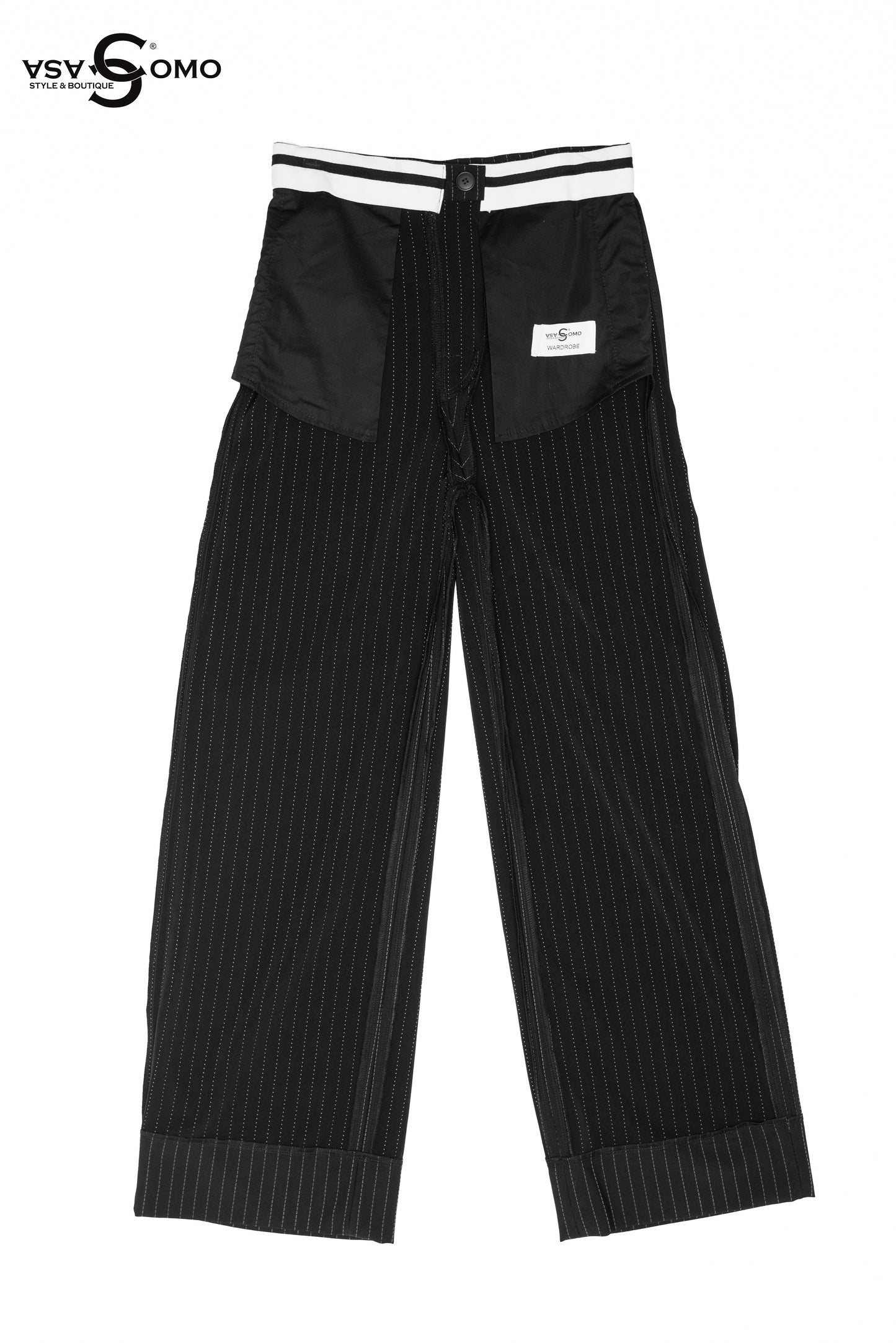 Model wearing black high-waisted pants with inside-out stitch details.