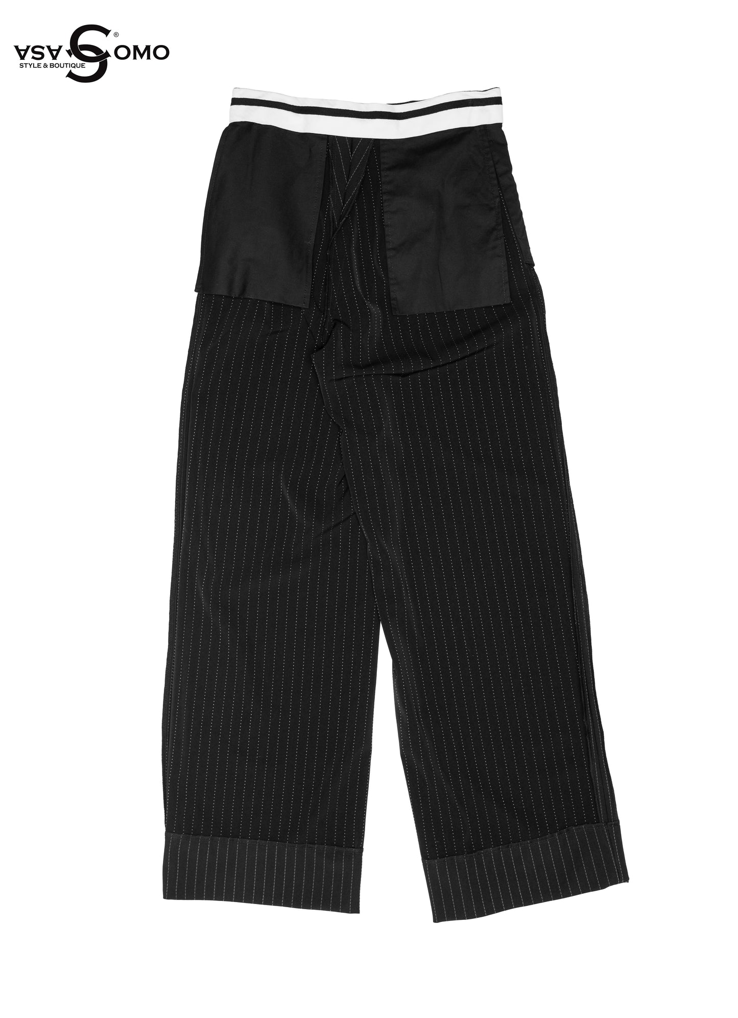 Model wearing black high-waisted pants with inside-out stitch details.