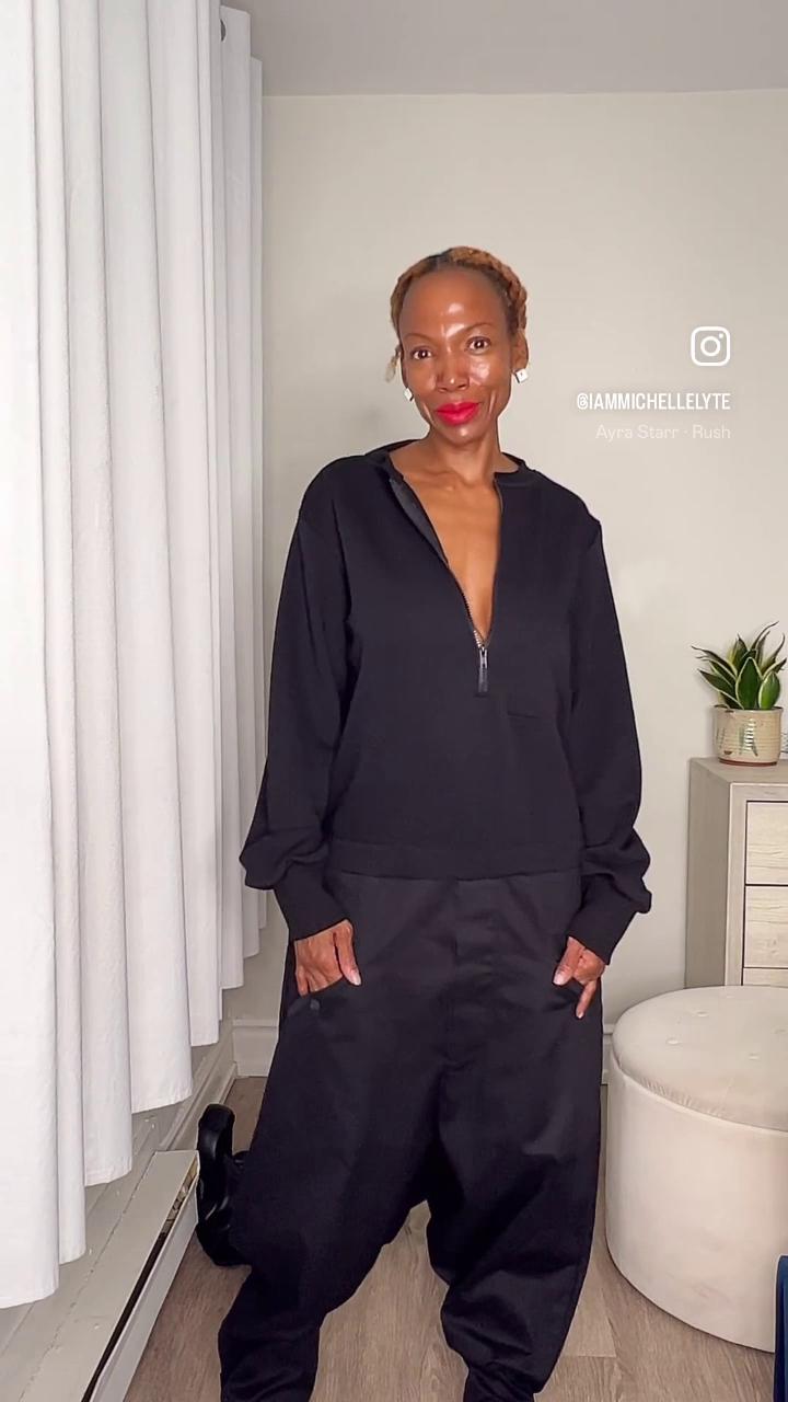 Front view of black two-tone jumpsuit with front zipper