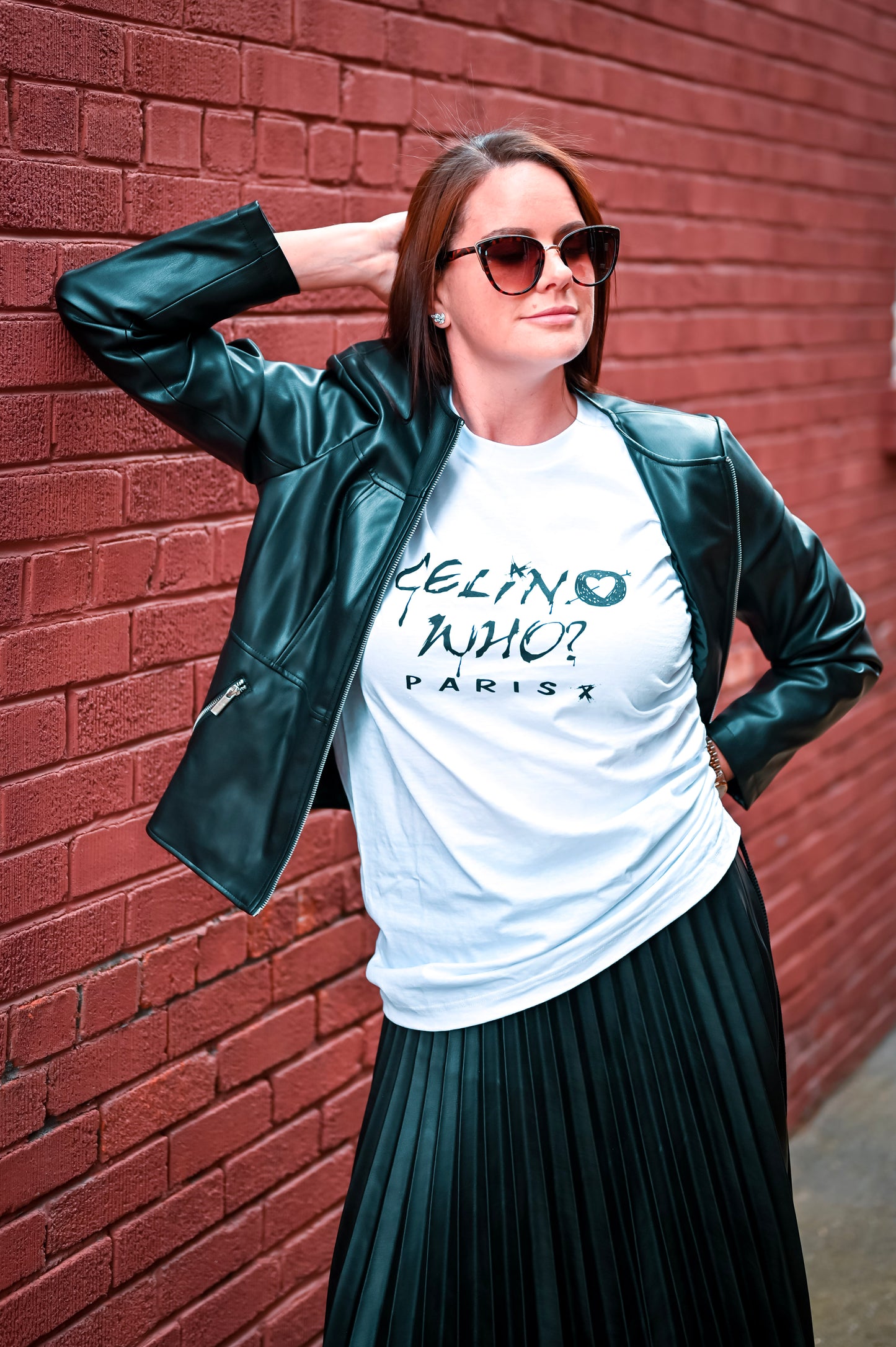 "Model wearing CELIN WHO? Paris T-shirt styled with a leather jacket, showcasing the bold graphic and modern street style. 2
