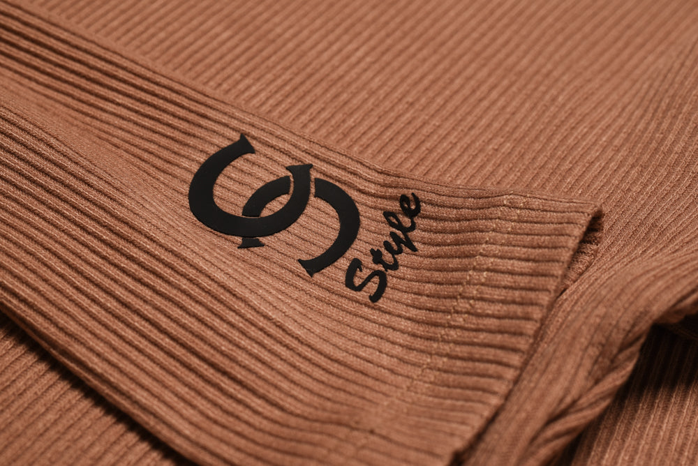 Casa Como black logo printed on sleeve of beige ribbed bodysui