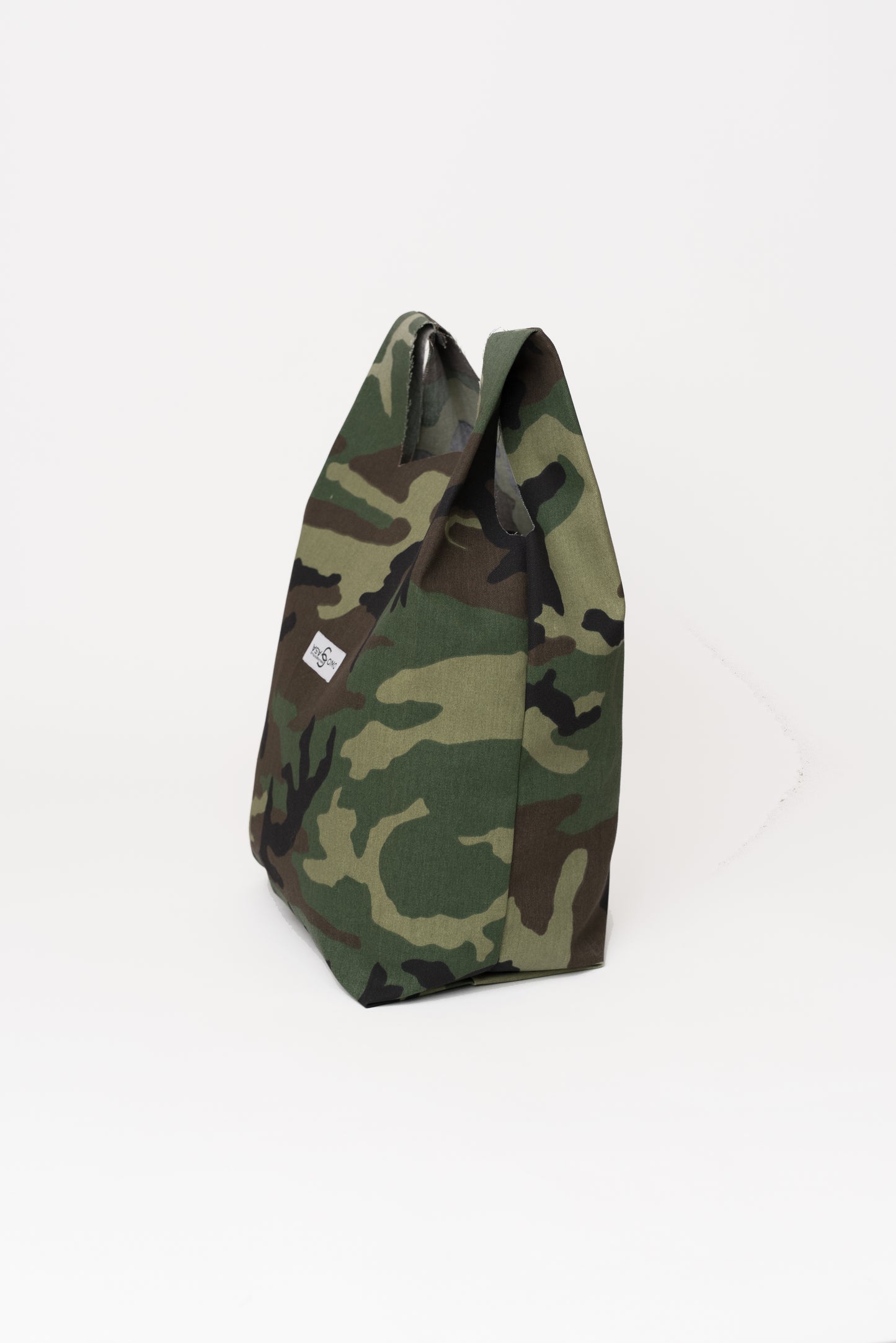 Side view of the camo tote bag showing its depth and lightweight structure.