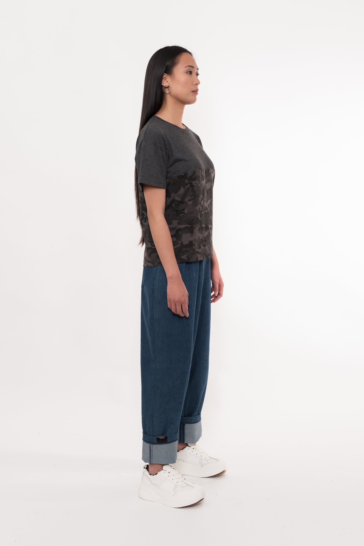 Side profile of model in camo and charcoal short sleeve tee