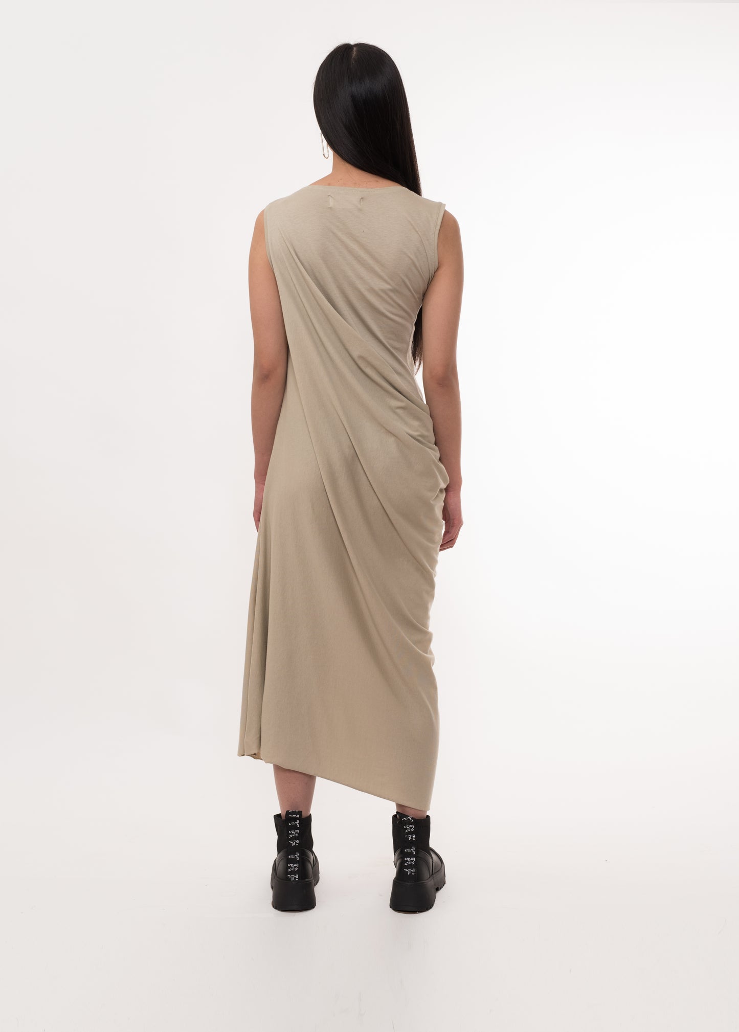 Back view of a beige draped midi dress with a soft, flowing silhouette
