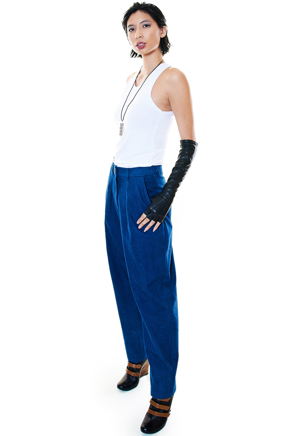 Lifestyle shot with white tank and black gloves styled with trousers