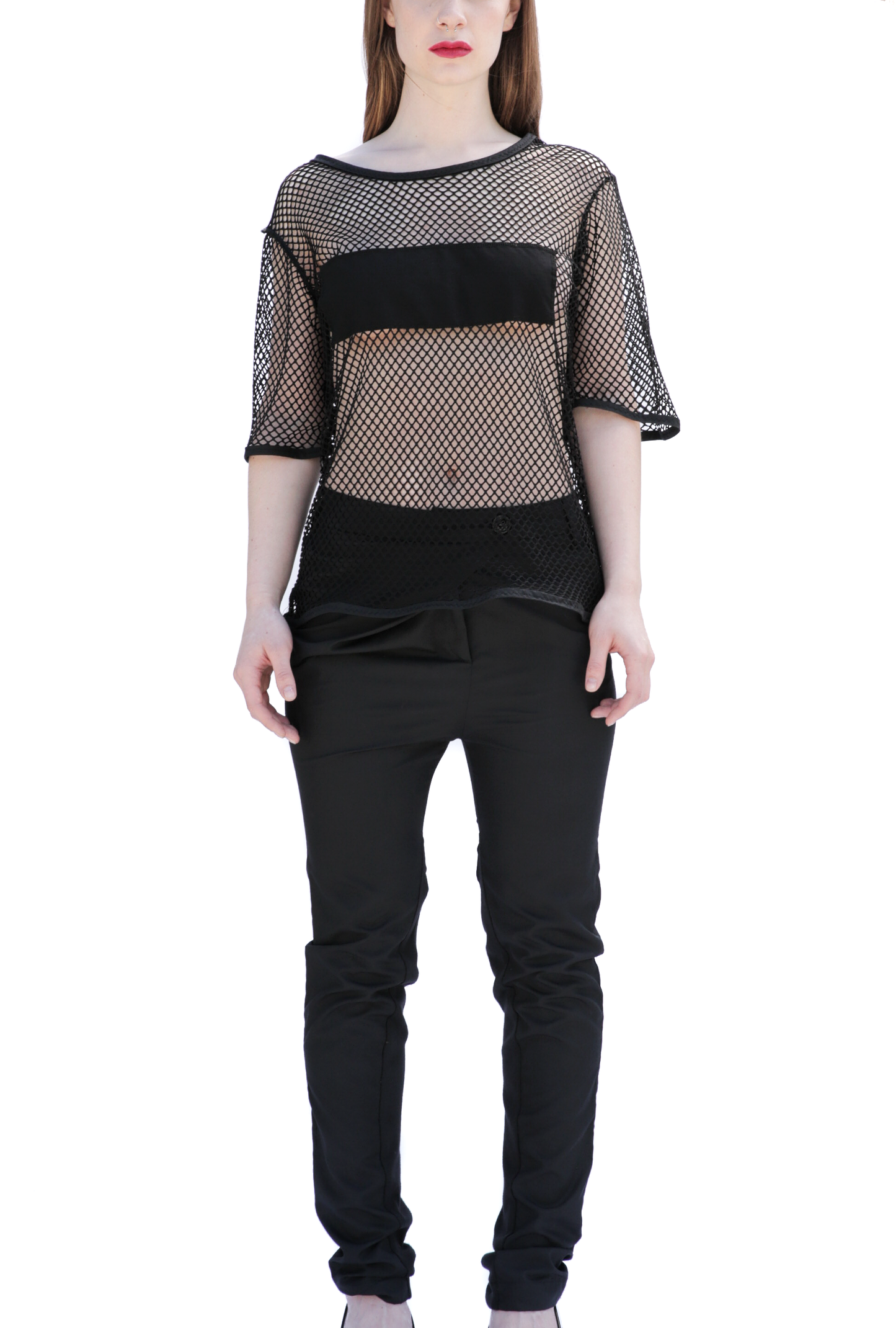 Front view of woman wearing sheer black mesh t-shirt over bandeau top