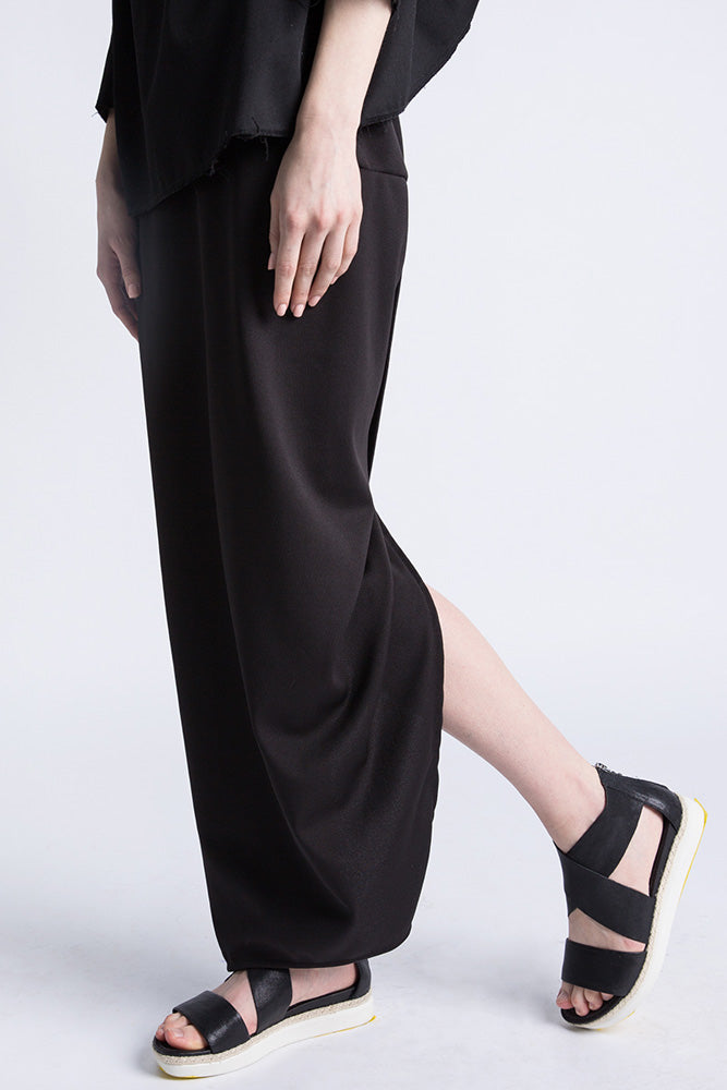 Side view of black slit skirt with elegant silhouette"