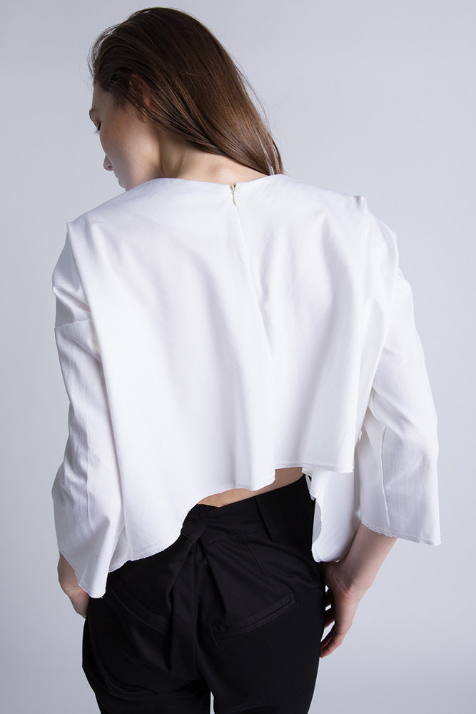 Back view of white blouse with open slit and gathered waist detail