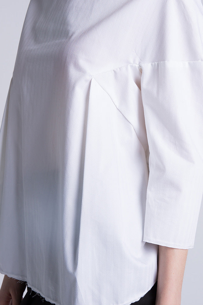 Detail shot of pleating and clean stitch work on blouse side