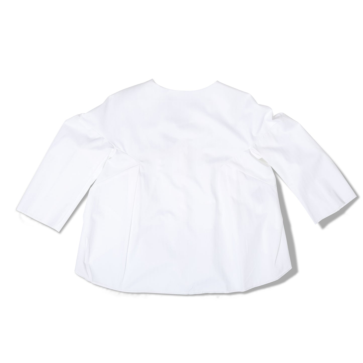 Studio flat lay of white blouse, front view