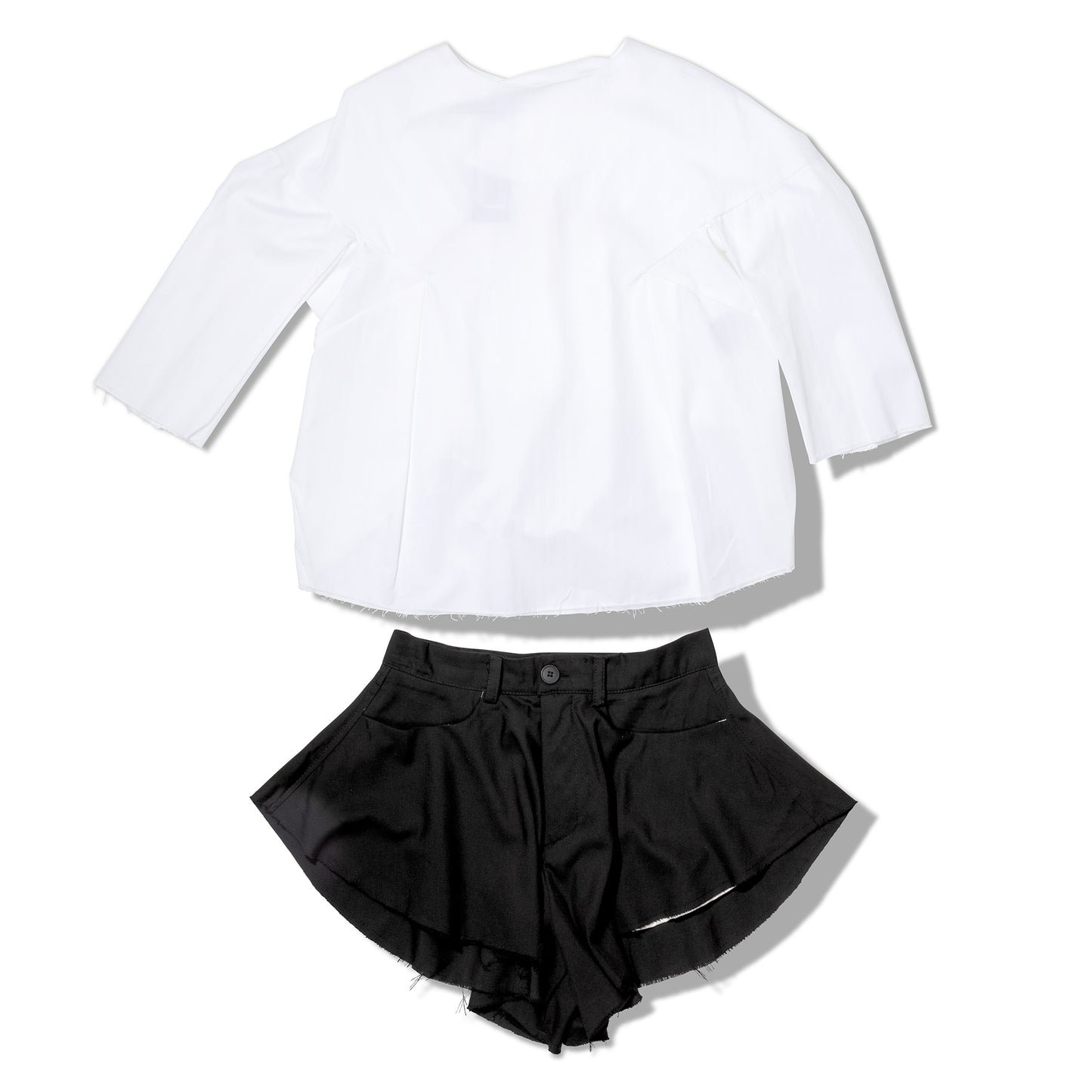 White blouse and black shorts outfit set - flat lay view
