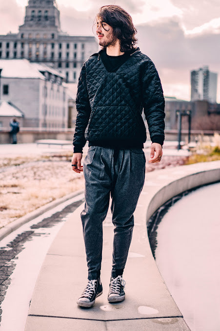 Model wearing black quilted waffle hoodie in urban setting – Casa Como Boutique