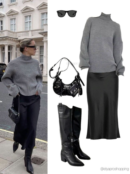 Grey oversized knit styled with a black midi skirt, knee-high black boots, and minimal accessories for an elevated everyday look.