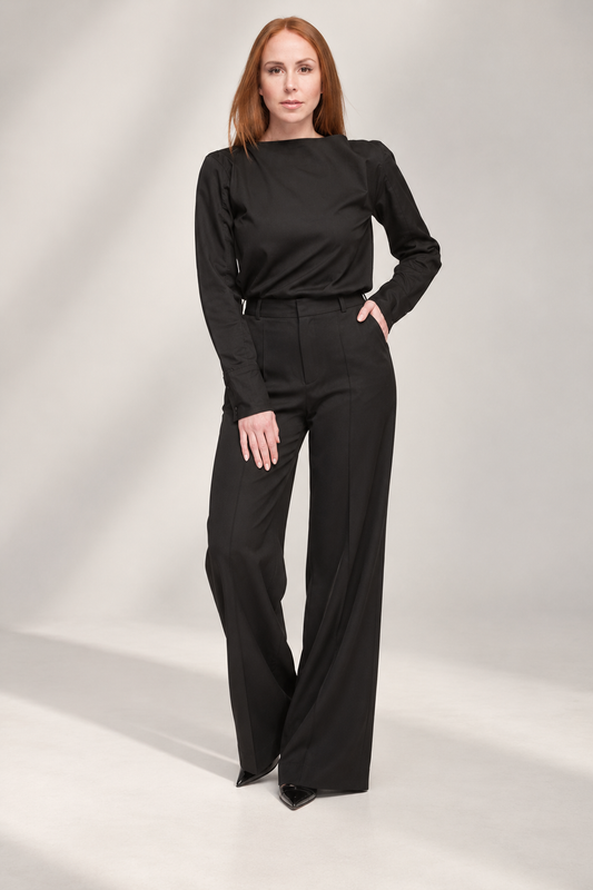 Front view of Casa Como black long-sleeve open-back shirt styled with tailored black trousers in a luxury monochrome look.
