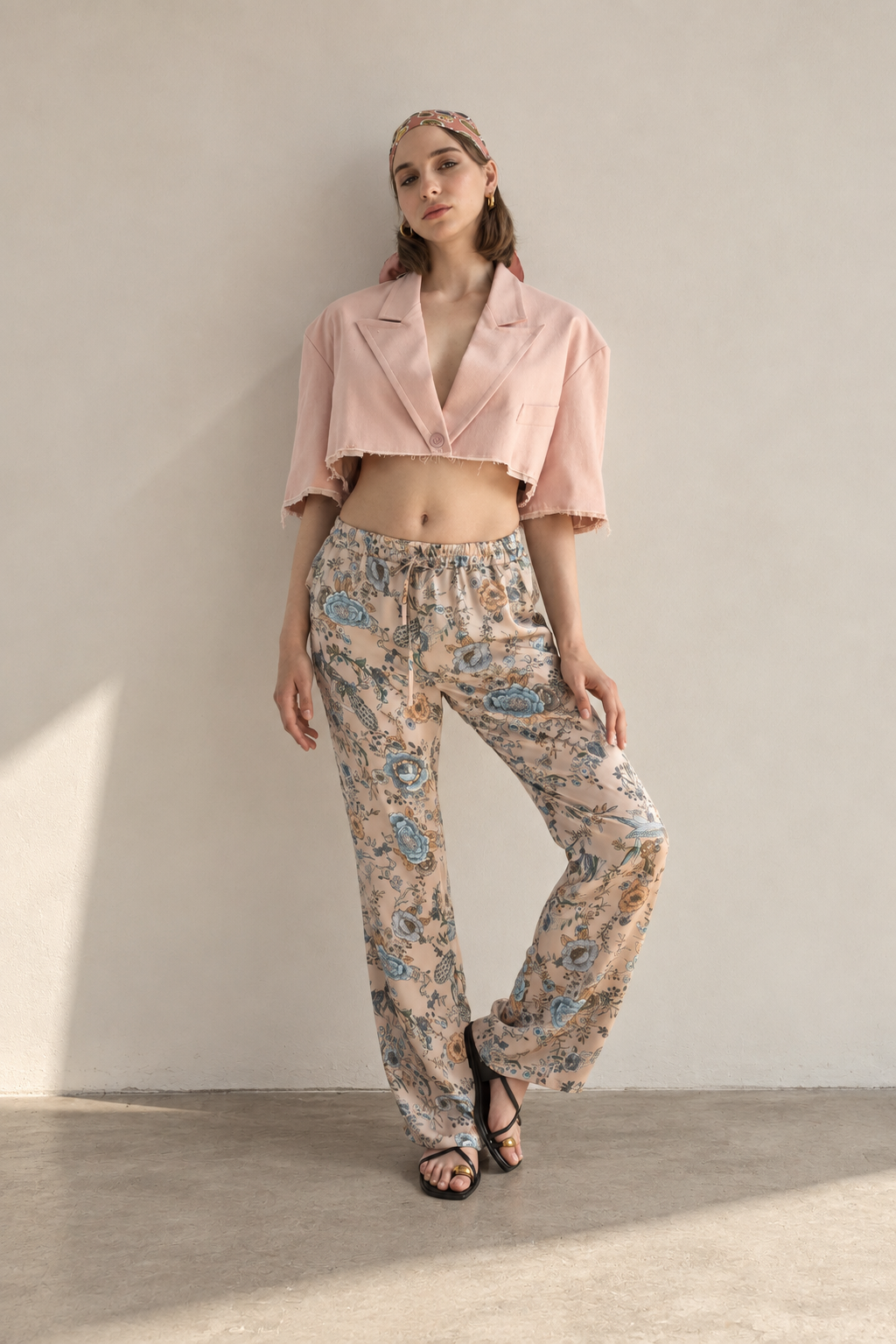 “Model wearing Casa Como floral relaxed trousers with a blush cropped blazer in an elevated editorial look.”