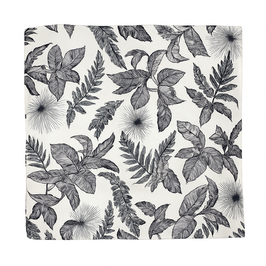 Square silk scarf with black and white tropical leaf print, laid flat on a white background.